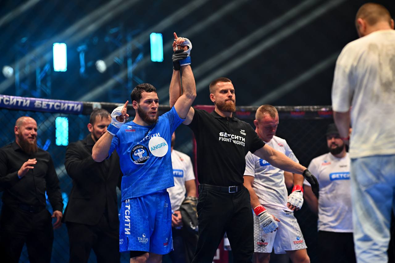 Рефери поднимает руку победителя в клетке БЕТСИТИ Fight Nights 142 в Майкопе